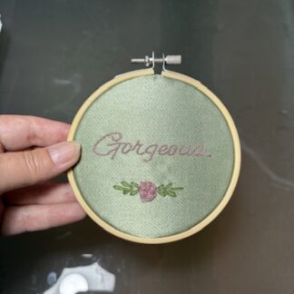 4" Embroidered Hoop Art "gorgeous" on green satin in pink with pink rose
